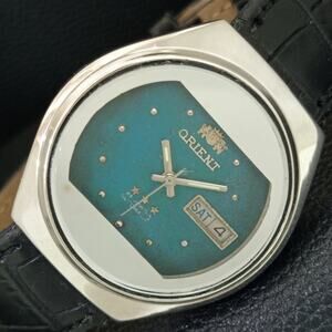 Vintage 1979 Orient Automatic Mens Silver Watch W/daydate & Teal accents